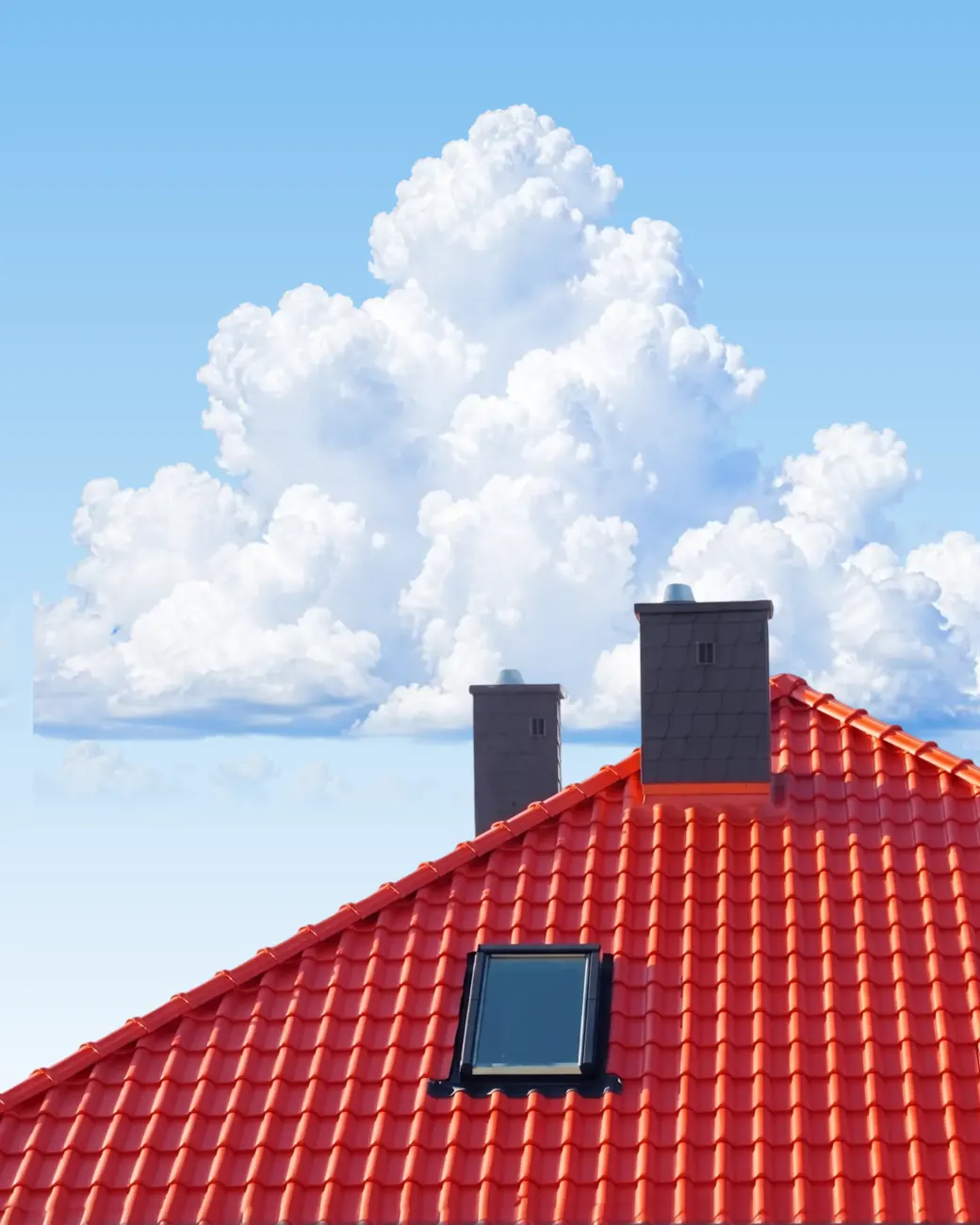 Red tiled Roofix roof against a blue sky with cumulus clouds
